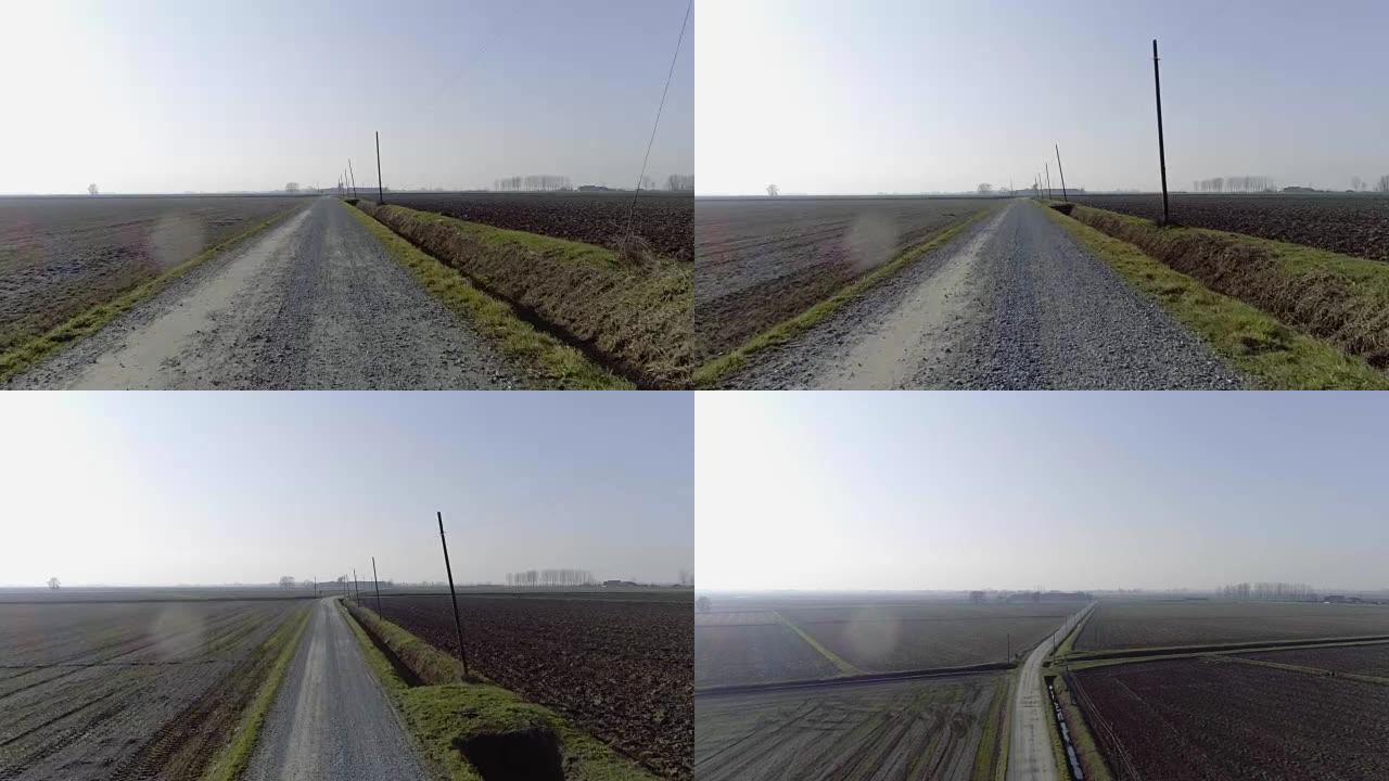 农村地区空中空旷的道路陆地步道路径。向前跟随4k无人机视频