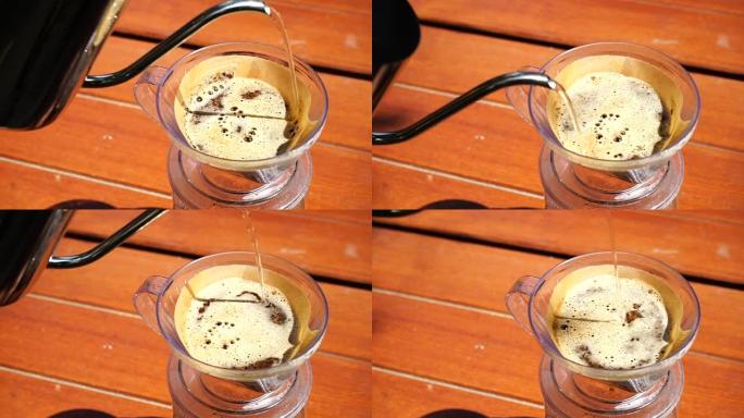 手滴咖啡，咖啡师在带过滤器的咖啡粉上倒水