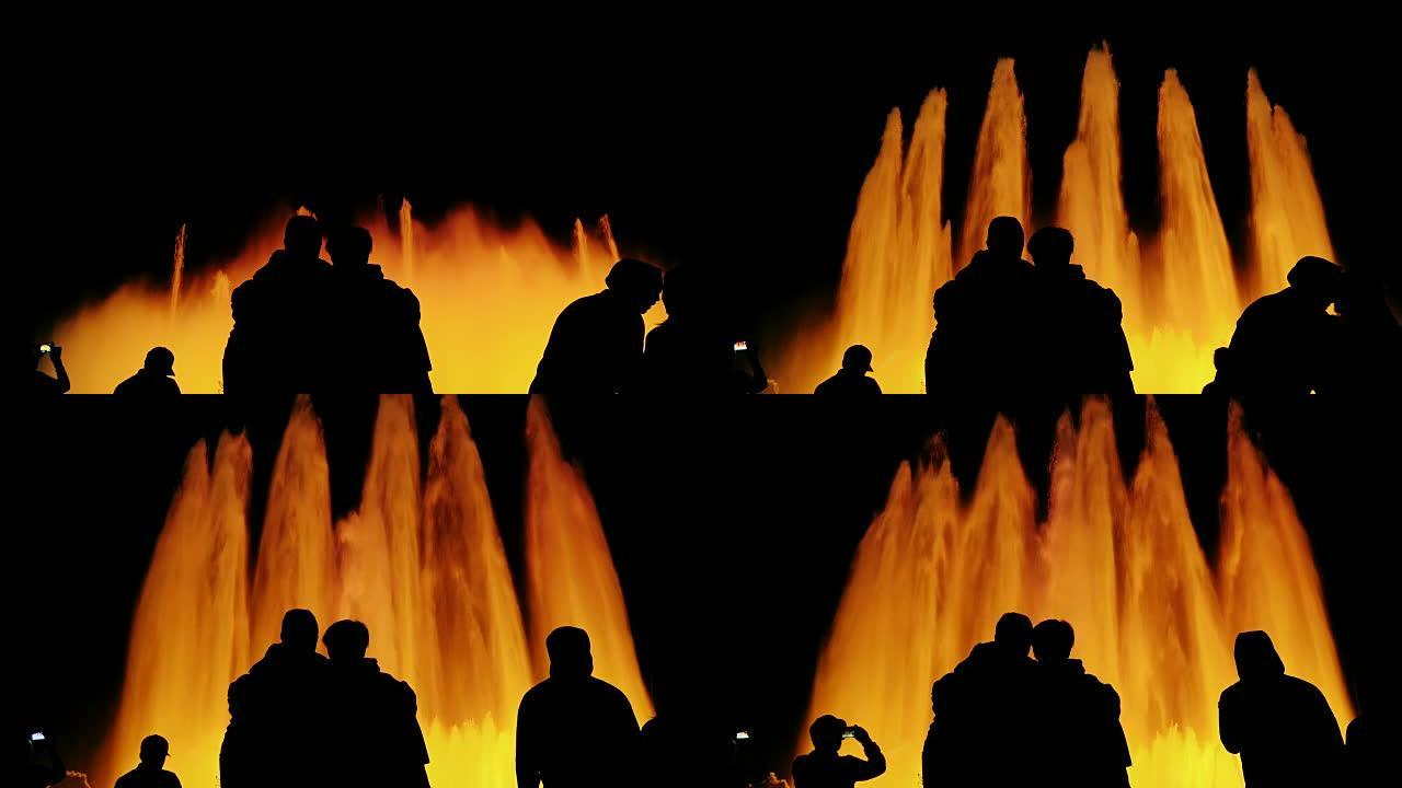 歌唱喷泉中无法辨认的人。喷泉点燃得很漂亮。巴塞罗那: 西班牙-受欢迎的旅游胜地
