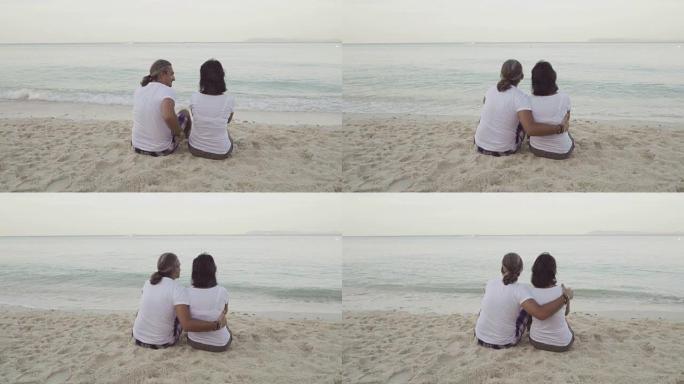 男人和女人坐在沙滩上