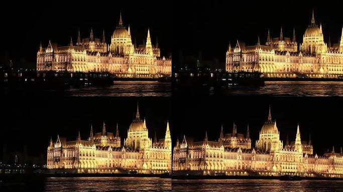 布达佩斯议会之夜。匈牙利议会大楼的夜晚，照明，与一艘游轮驶过多瑙河