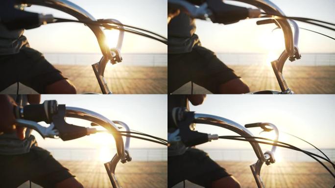 日出时靠近海边的自行车手柄杆，特写