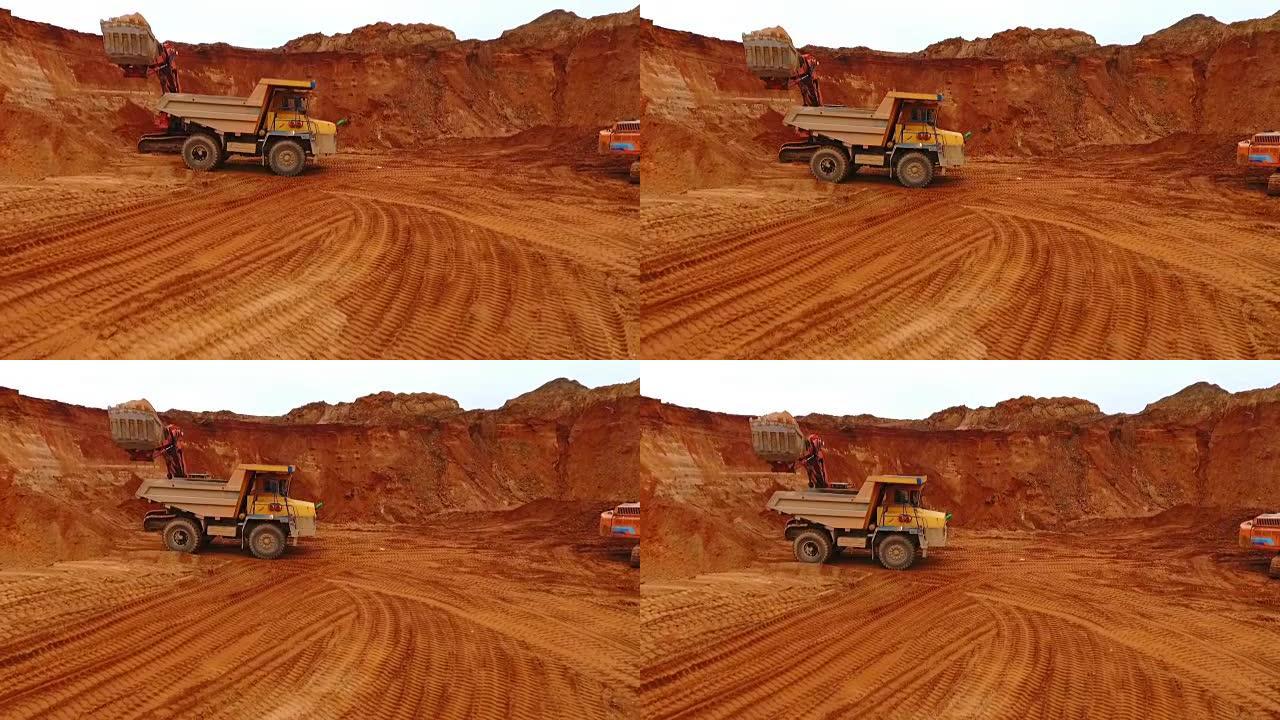 沙矿的自卸车。在采砂场工作的采矿卡车的无人机视图