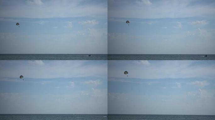 旅行者在海上用快艇滑翔伞