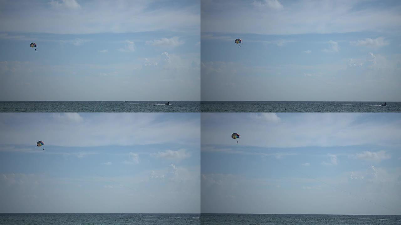 旅行者在海上用快艇滑翔伞