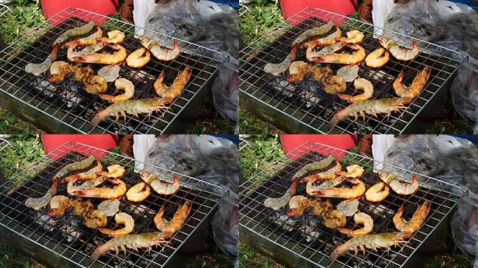 双手是烤制海鲜烤架或派对上的木炭烧烤。