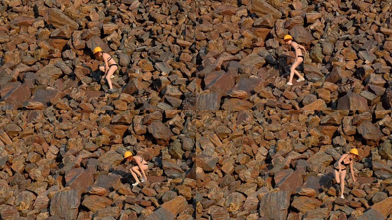 红色矿石。红色矿石山。一个穿着泳衣的女孩躺在红色的矿石上