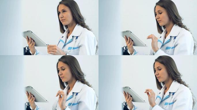 女医生在诊所使用平板电脑
