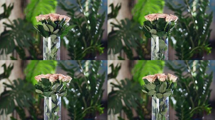 花束在光线，旋转中，花卉成分由玫瑰卡布奇诺咖啡组成。神圣的美丽。背景是很多绿色植物