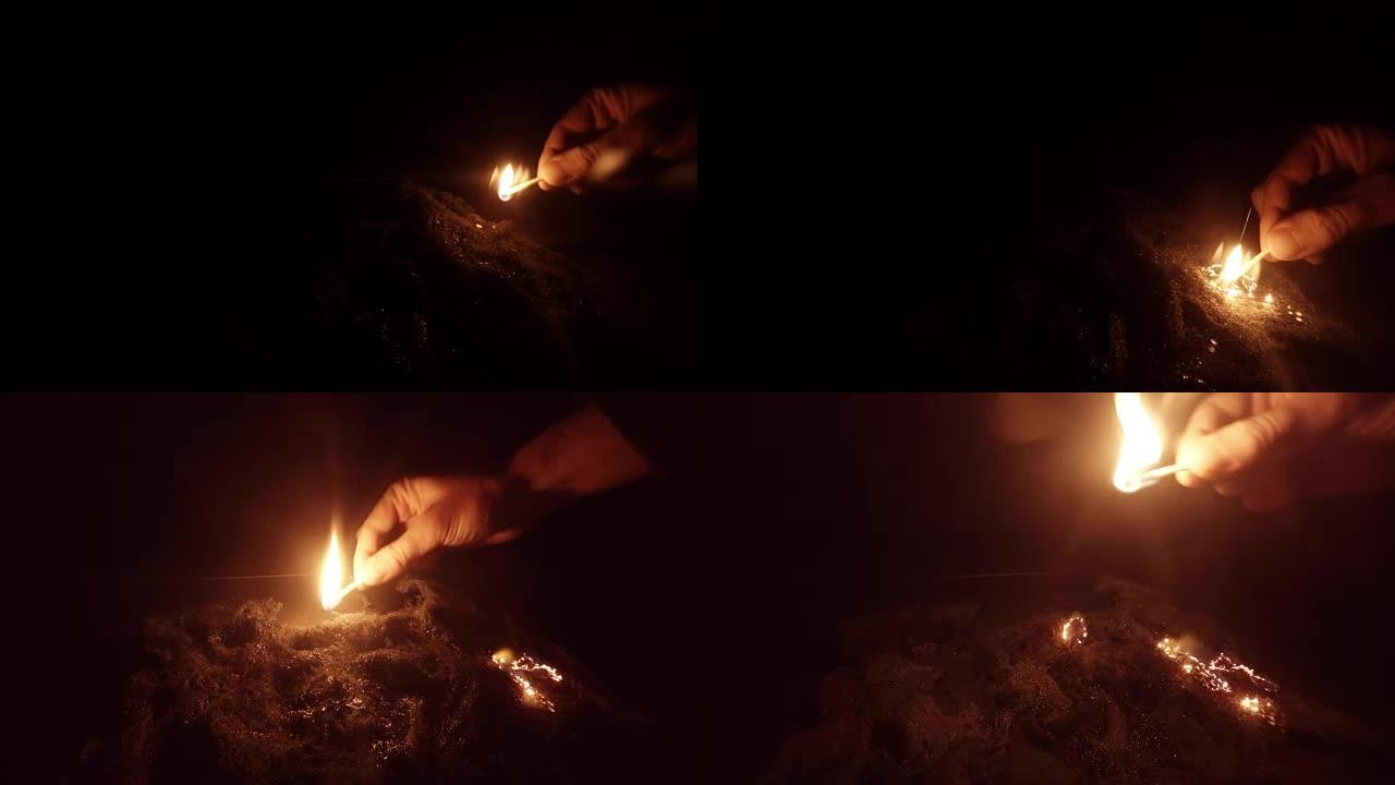 手中的火柴在黑暗中的几个地方点燃钢丝绒