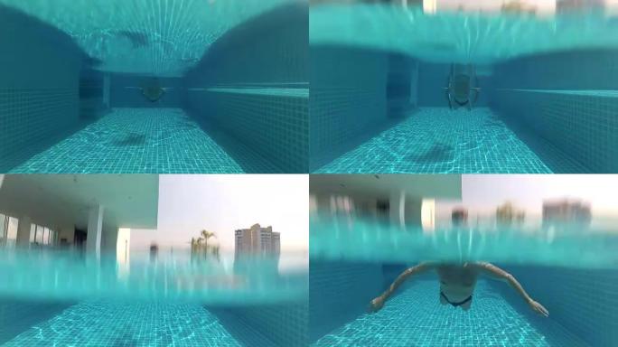 运动型年轻人在游泳池游泳蛙泳风格，水下景观。动作摄像机