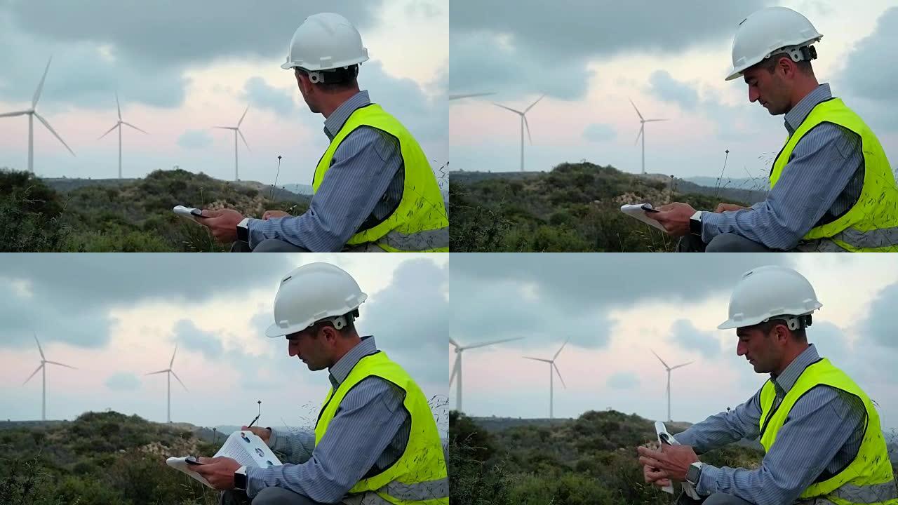 风力发电的员工在检查工厂时做笔记