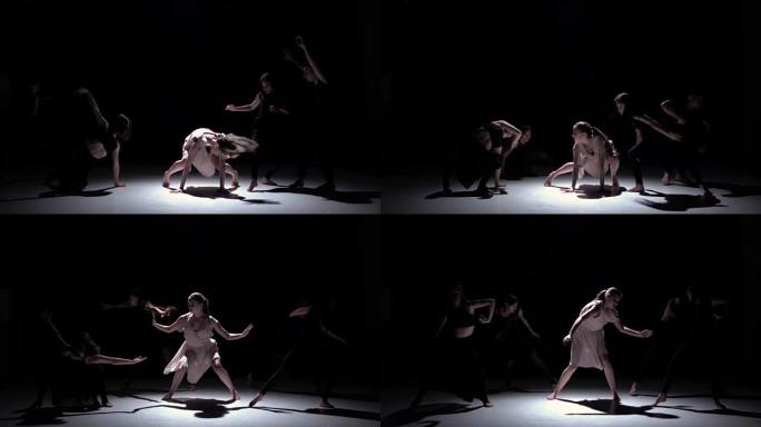 开始五位舞者在黑色，阴影，慢动作上的当代舞蹈表演