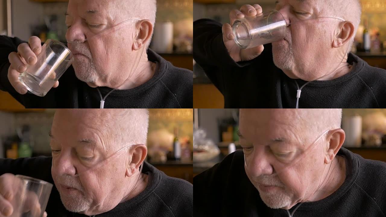 衰老的婴儿潮一代老人戴着氧气面罩从玻璃杯中喝酒