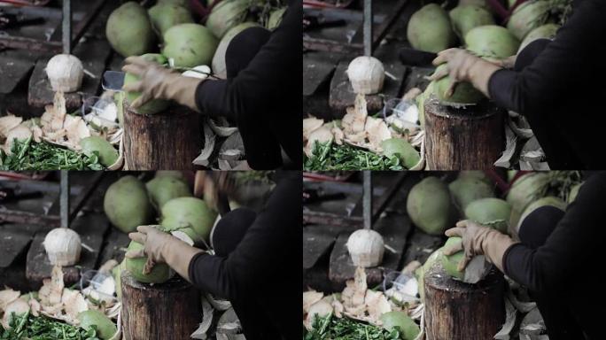 街头卖家用大刀打开椰子。