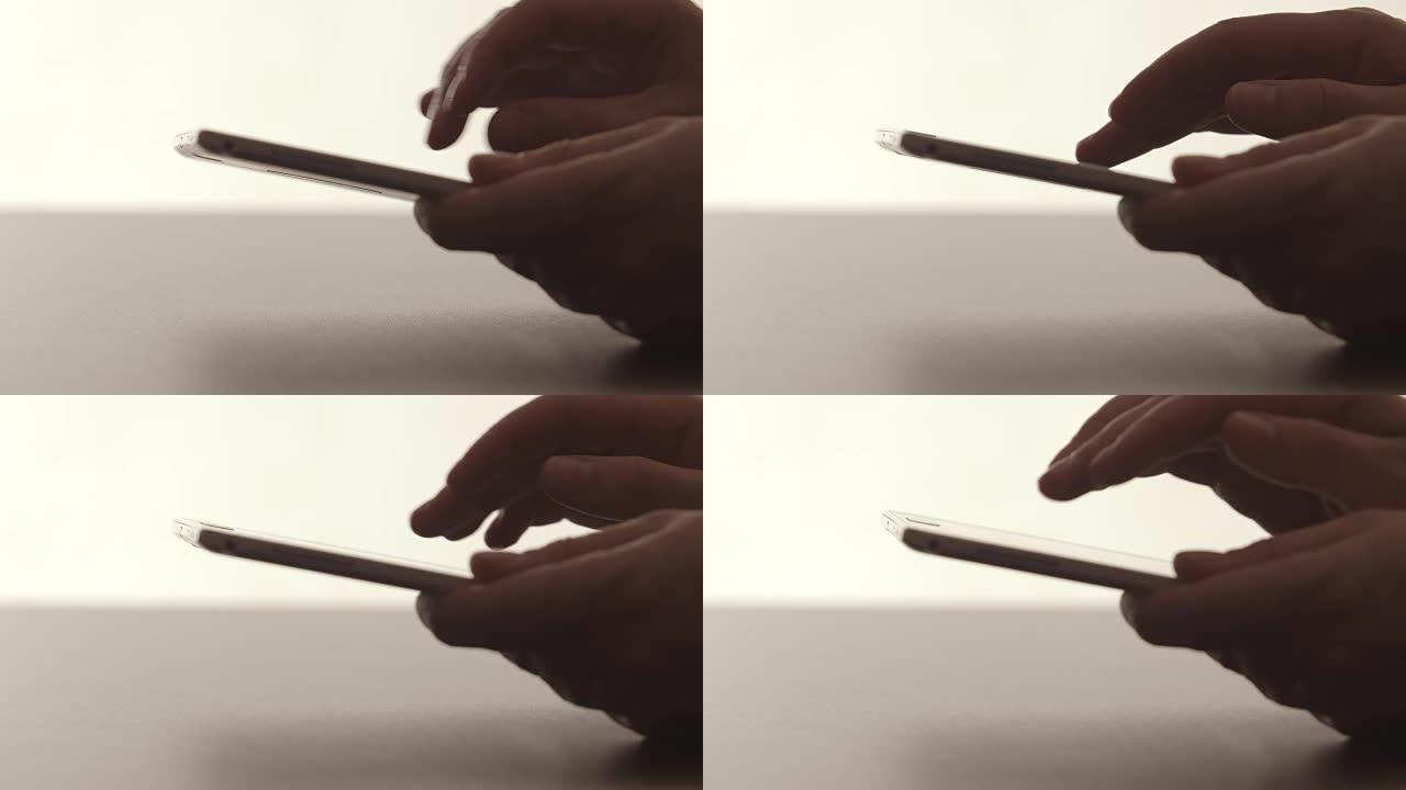 侧视图: 人类的双手将平板电脑放在桌子上