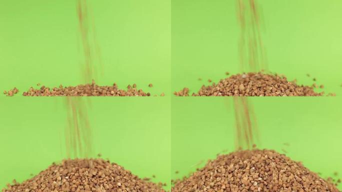 落在绿色屏幕上的荞麦堆上的谷物荞麦
