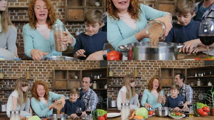 快乐的家庭在厨房一起烹饪健康晚餐父母和孩子一边做饭一边聊天