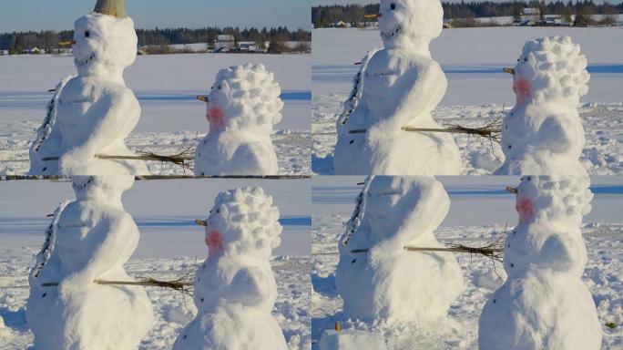 两个大雪人站在地上