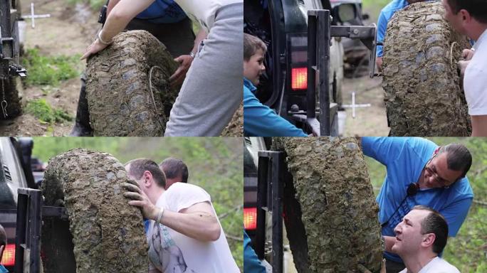 两个男人在远征SUV的后门上设置了被刺穿的车轮。