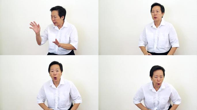 亚洲女性老人看着相机摇头，做手势拒绝，说不