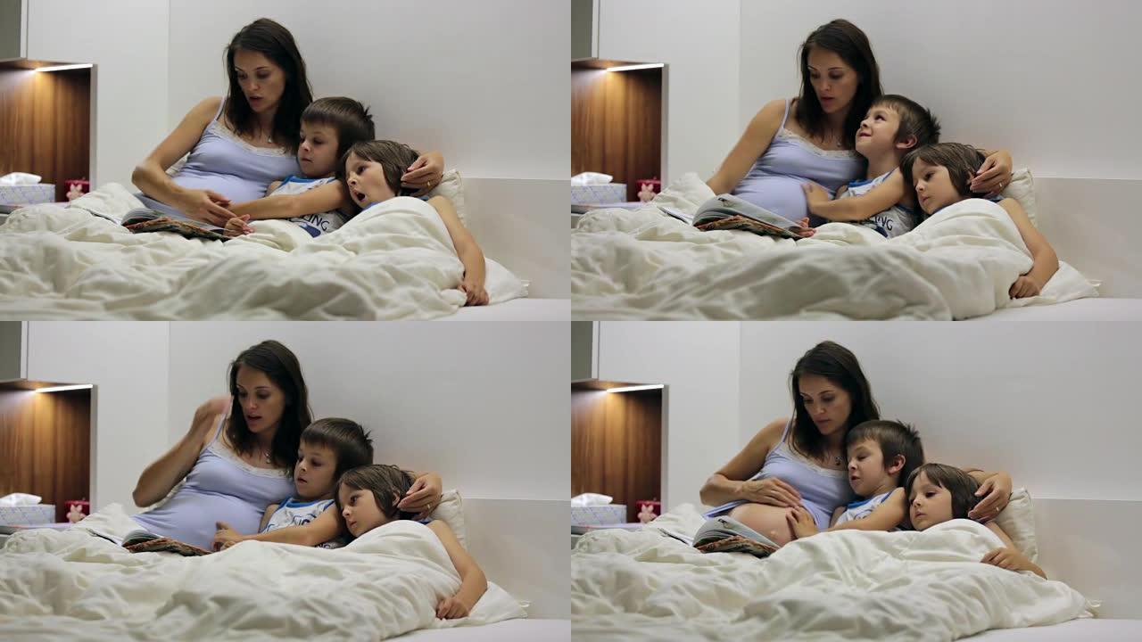 怀孕的妈妈，在床上为儿子们读睡前故事
