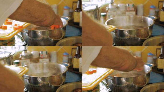 一名男子以慢动作将胡萝卜放入一锅热气腾腾的汤中