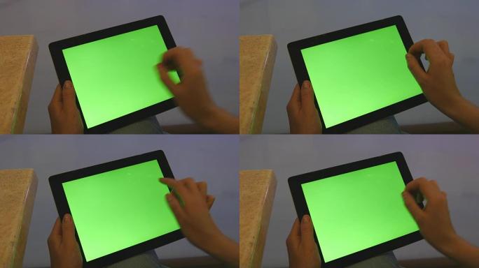 在购物中心使用绿屏平板电脑的女性双手。