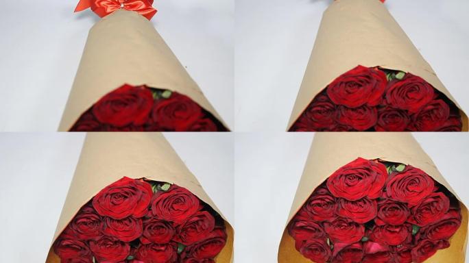 纸质包装的红玫瑰花束。机架聚焦