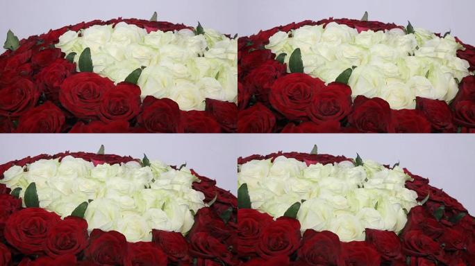 红玫瑰花束，里面有心形的白玫瑰。特写