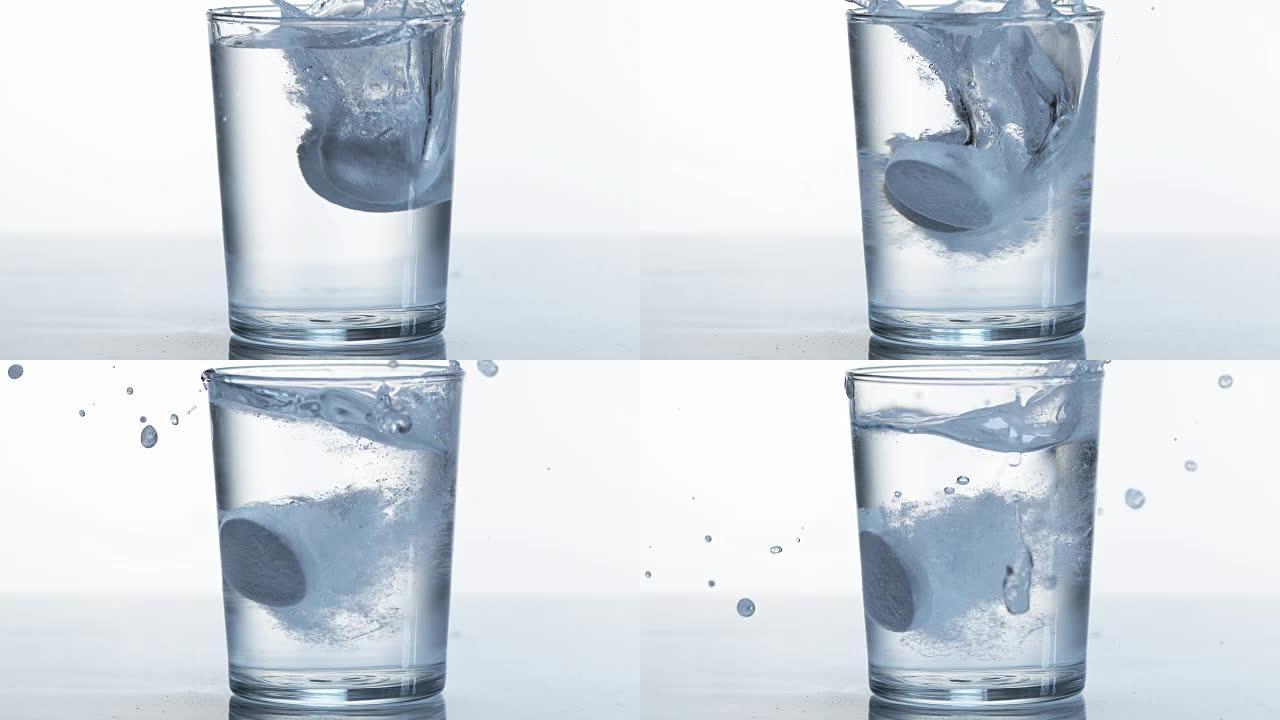 平板电脑掉落并溶解在白色背景下的一杯水中，慢动作4K