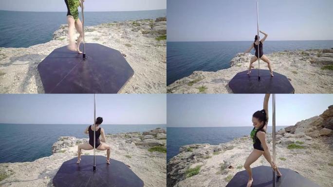 一名年轻女子在悬崖上使用便携式舞蹈和健身钢管。替身拍摄