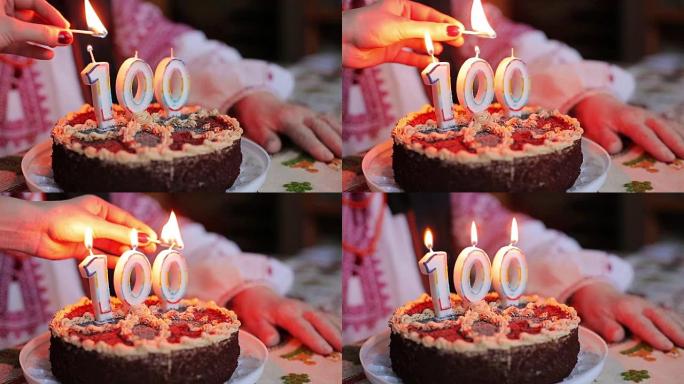 点燃蛋糕上的蜡烛。100周年