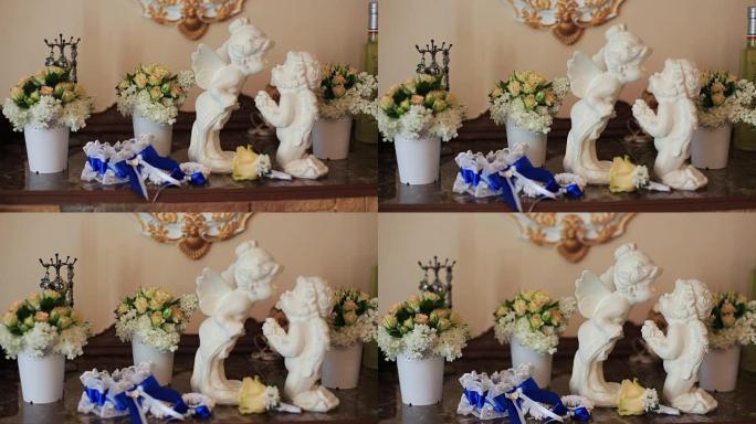 白色陶瓷坐姿天使亲吻花朵背景