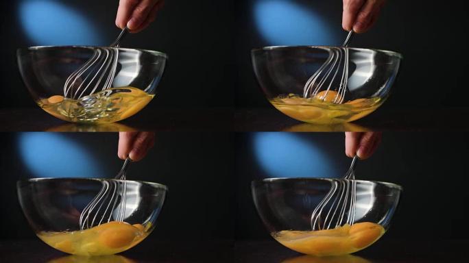 用晶须在玻璃碗中搅拌鸡蛋