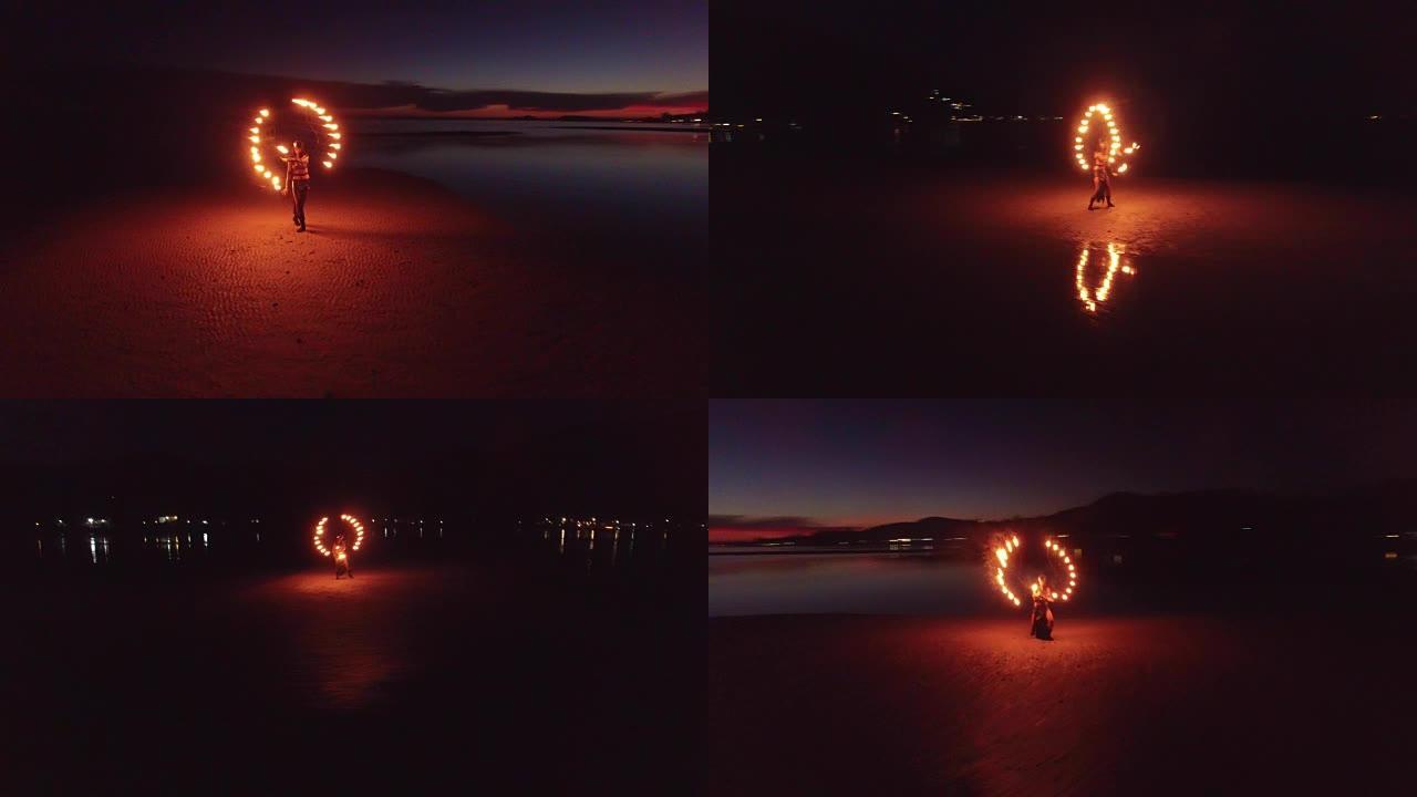 日落时在沙洲海滩上跳舞的火表演