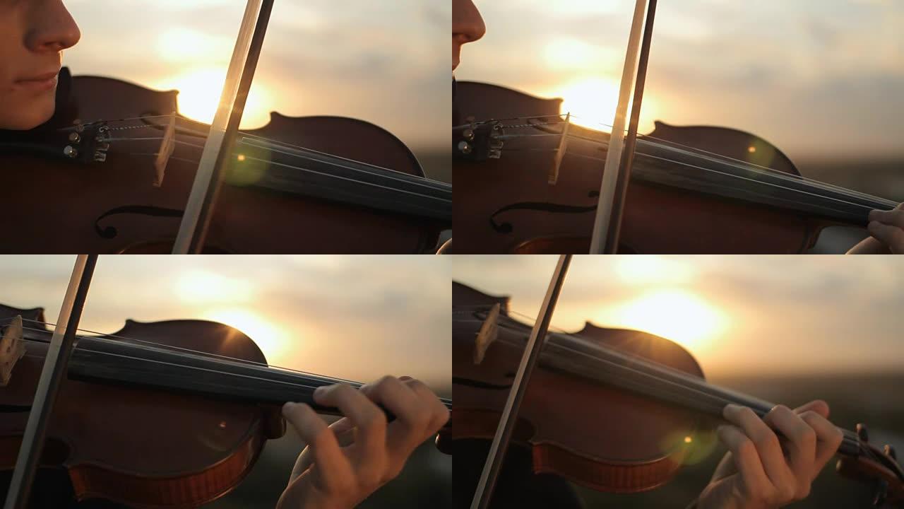 小提琴。小提琴手在日落时演奏。弦小提琴和弓