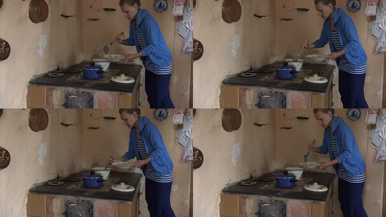 丫头女人在复古炉子上从沸腾的锅里摘下煮熟的饺子。