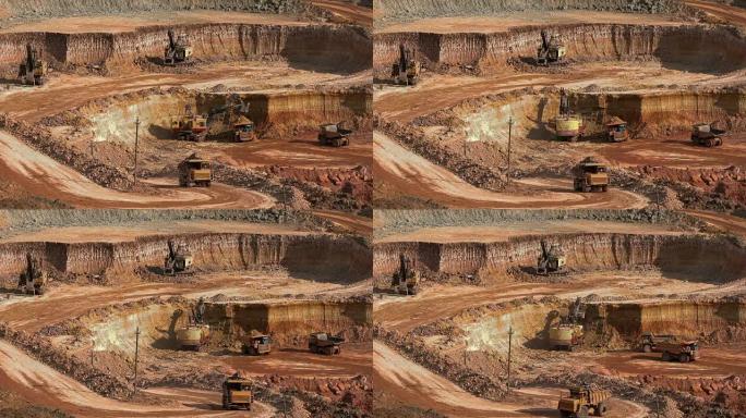 挖掘机将矿石装载到自卸卡车中。这个地区开采矾土、铝和其他矿物。露天。我操作。铝土矿的猎物。
