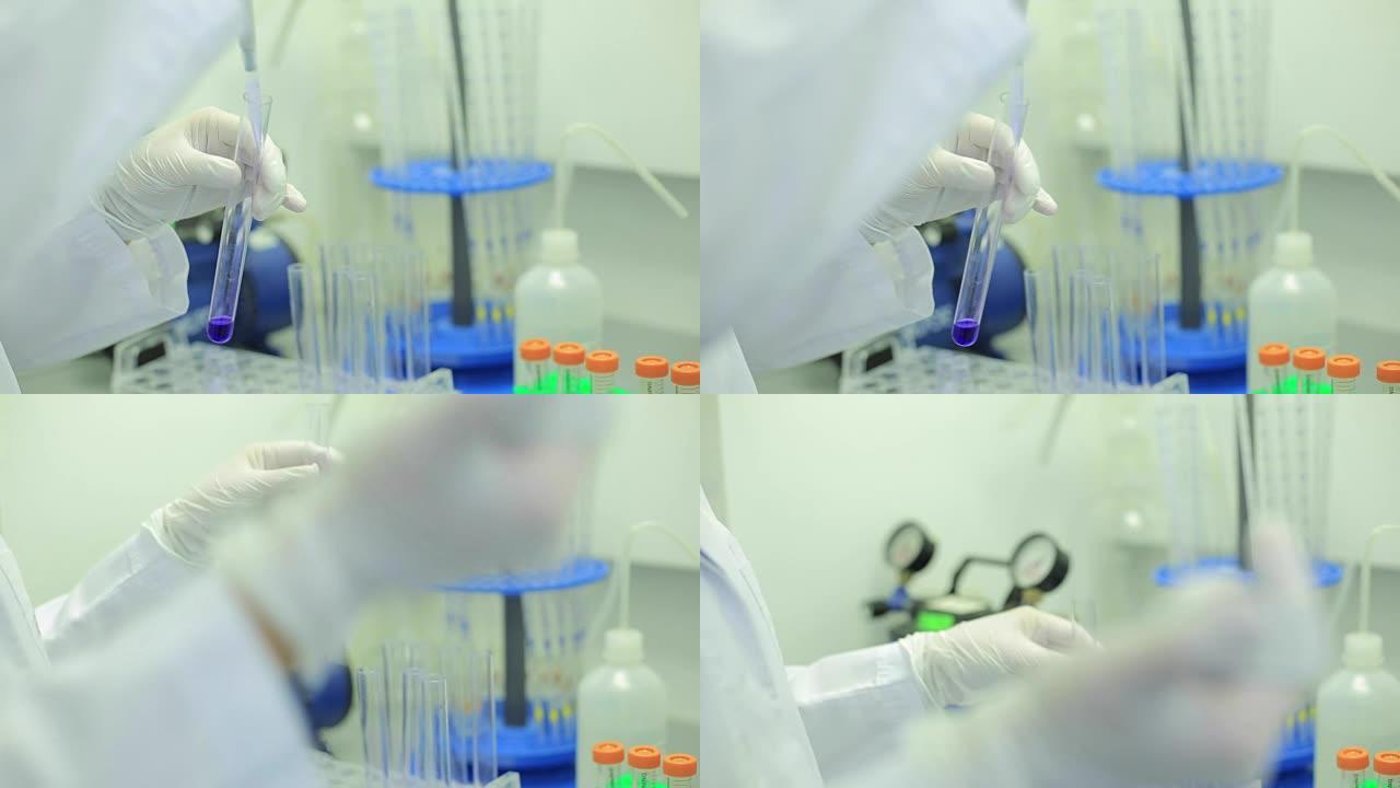 试管特写。医疗设备。科学家在实验室中使用微量移液管的特写镜头。实验室技术人员将液体注入微量滴定板。试