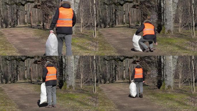 带袋子的人在公园的小路上捡起空的塑料瓶