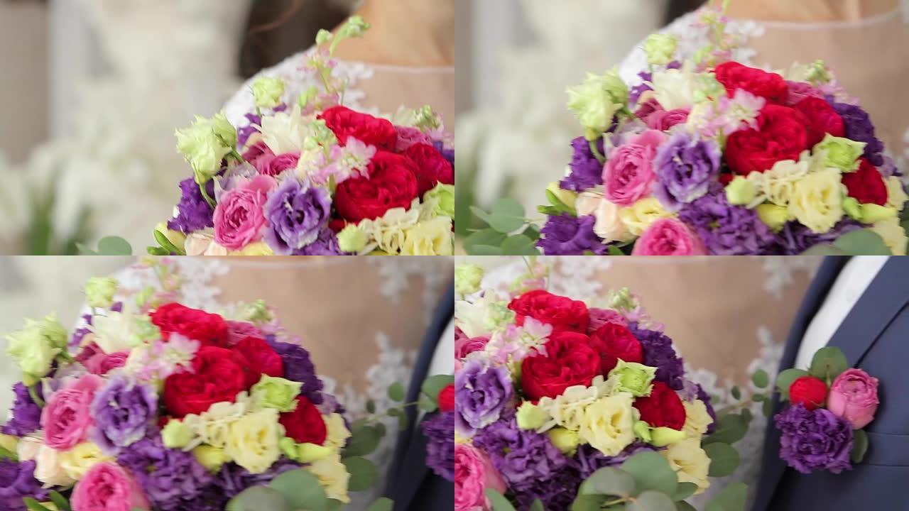 新娘的花束。新娘的结婚饰品。新娘用手触摸花瓣。