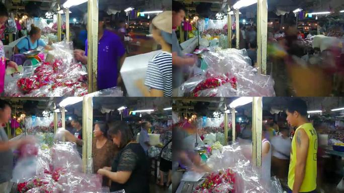 曼谷的延时花卉市场 (Pak Khlong Talat)。花卉商和贸易商正在销售，买家购物更多。这是