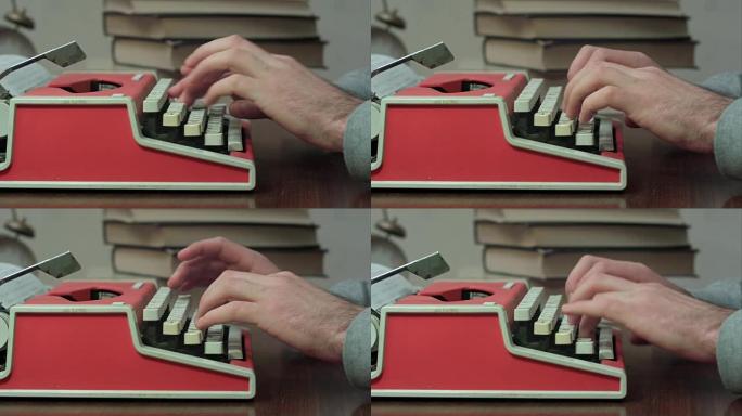 男人的手在红色打字机上打字