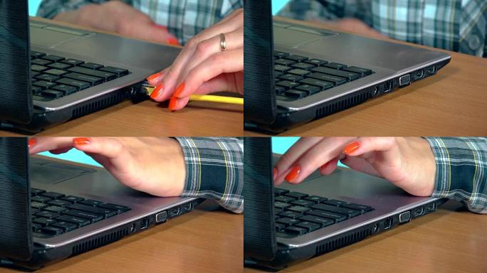 女性手断开互联网局域网电缆到笔记本电脑。特写