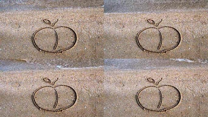 苹果在沙子上画画。