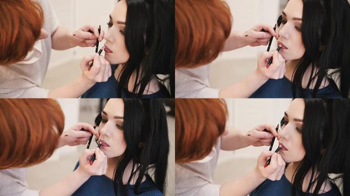 化妆师用唇笔抚摸嘴唇，让年轻女性的嘴唇化妆