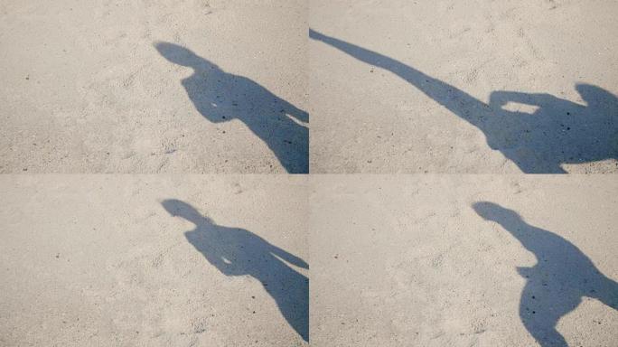 在沙滩上，你可以看到阴影，一个运动女孩的轮廓，她执行抬腿，完成踢，训练战斗，与阴影的战斗。慢动作