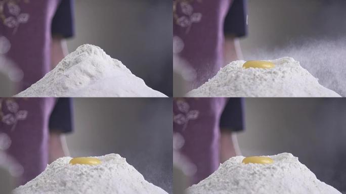 鸡蛋落入面粉原料的慢动作。镜头食物