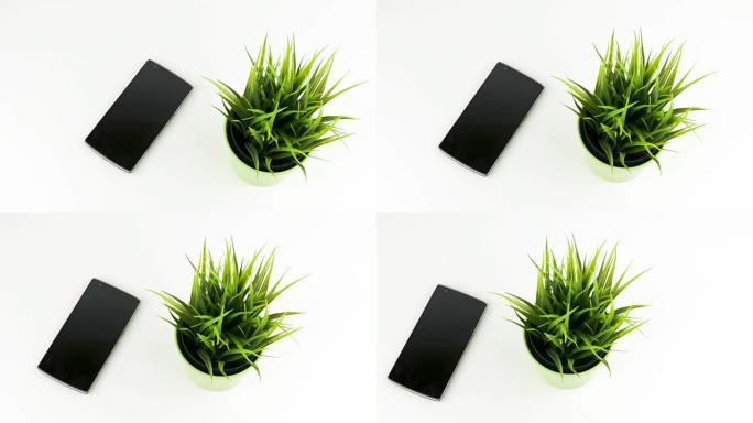 陶瓷锅淘运动中绿草旁的智能手机